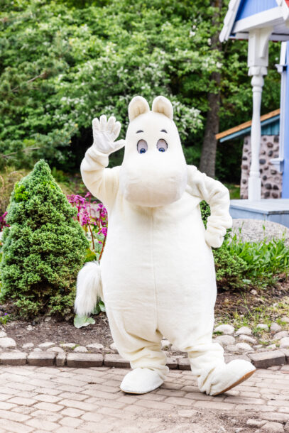 Moomintroll in front of the Moominhouse.